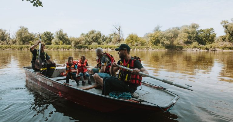 Een gezin met reddingsvesten in een roeiboot op een meer