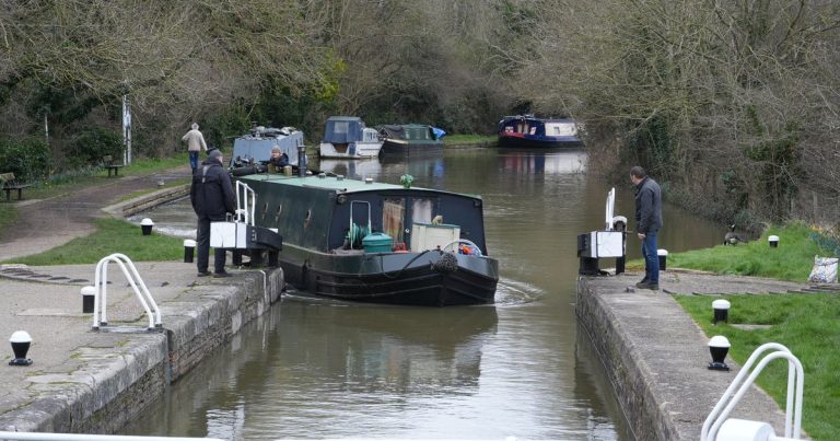 Een schip vaart door een sluis in een kanaal